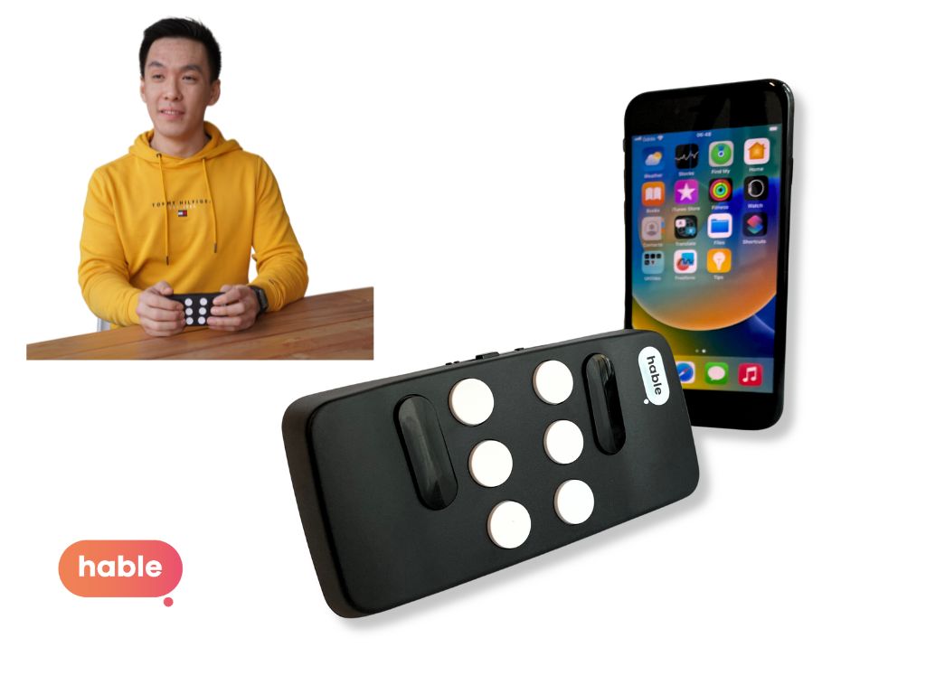 The Hable One Smallest Braille Keyboard, with a standard 8-dot layout sitting next to a smartphone.