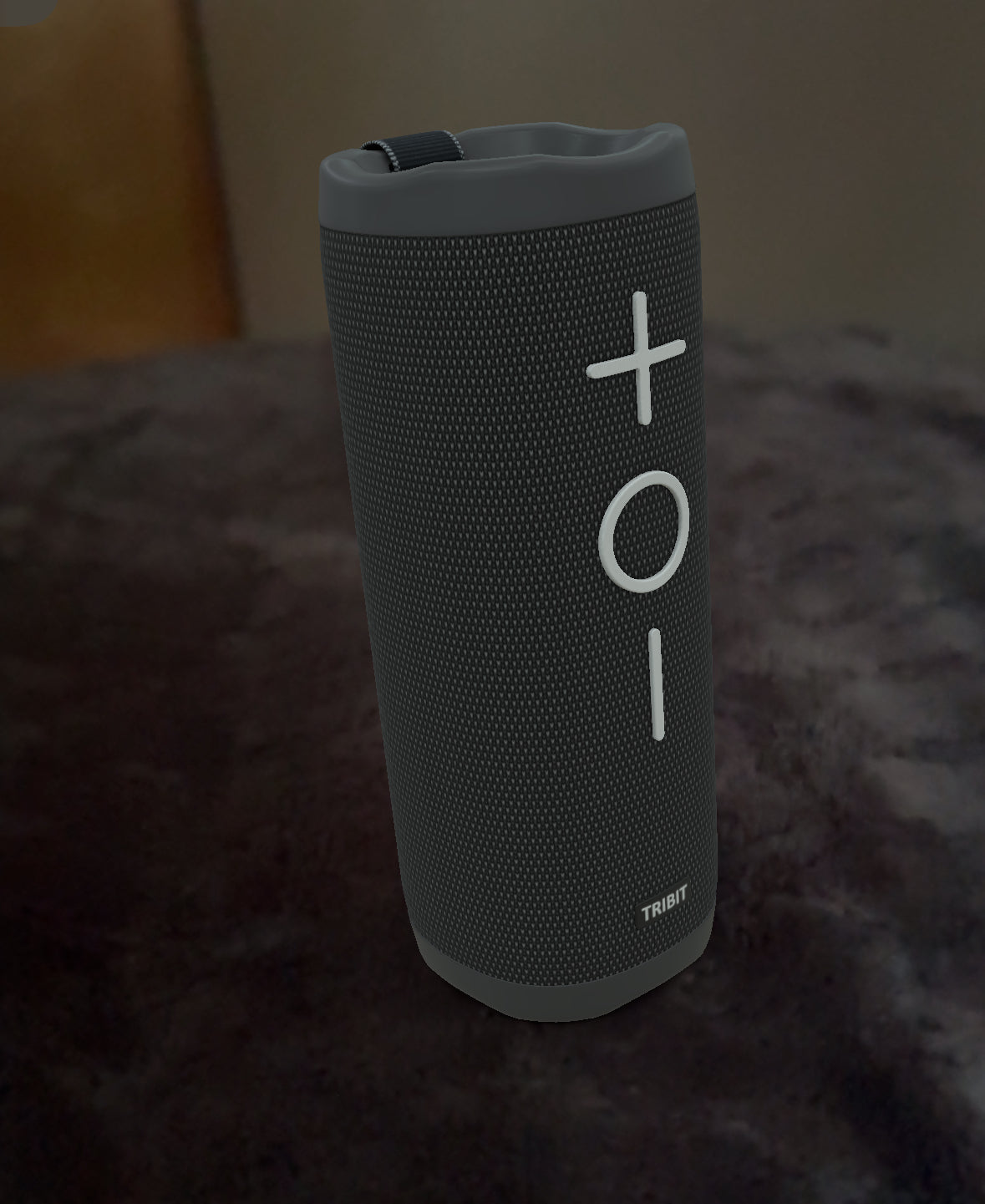 Black Tribit StormBox 2 Bluetooth speaker on a dark surface.