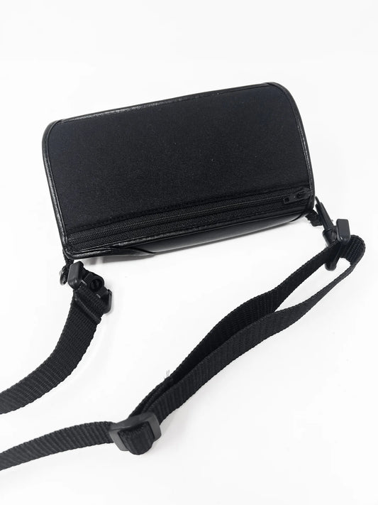 The black leather BT Speak case, with a protective key cover and an adjustable strap attached.