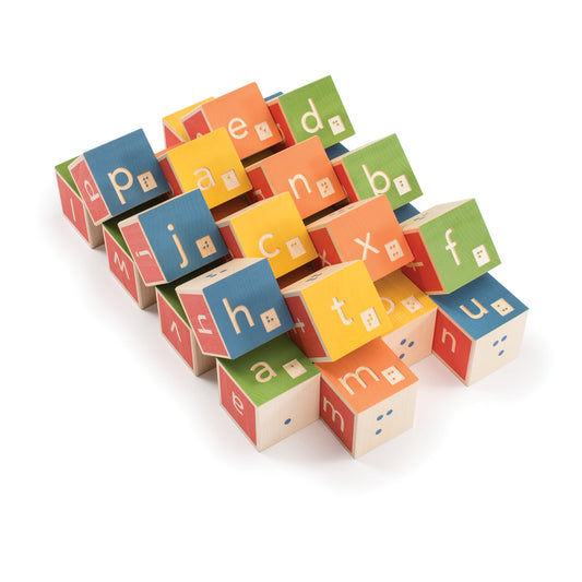 A scattered arrangement of Uncle Goose Braille Alpha blocks.