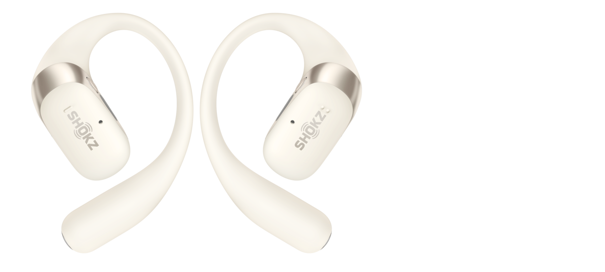 Beige Shokz OpenFit 2s against a solid black background