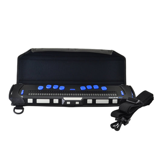 Freedom Scientific Focus 40 Blue 5th Generation braille display in open black Turtleback case, showing blue input keys, braille cells, gray front controls and a rolled shoulder strap.