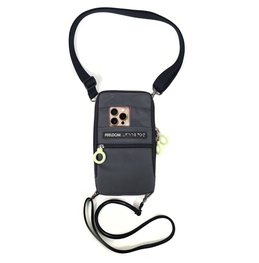 Front of a dark-colored Navi-Pal. A smartphone sits in the pocket, its rear camera perfectly positioned in the pouch's designated window.