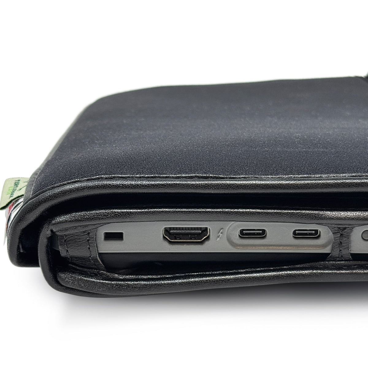 Side close-up of the BrailleNote Evolve in its case, showing openings for an HDMI port and two USB-C ports beneath the cover.