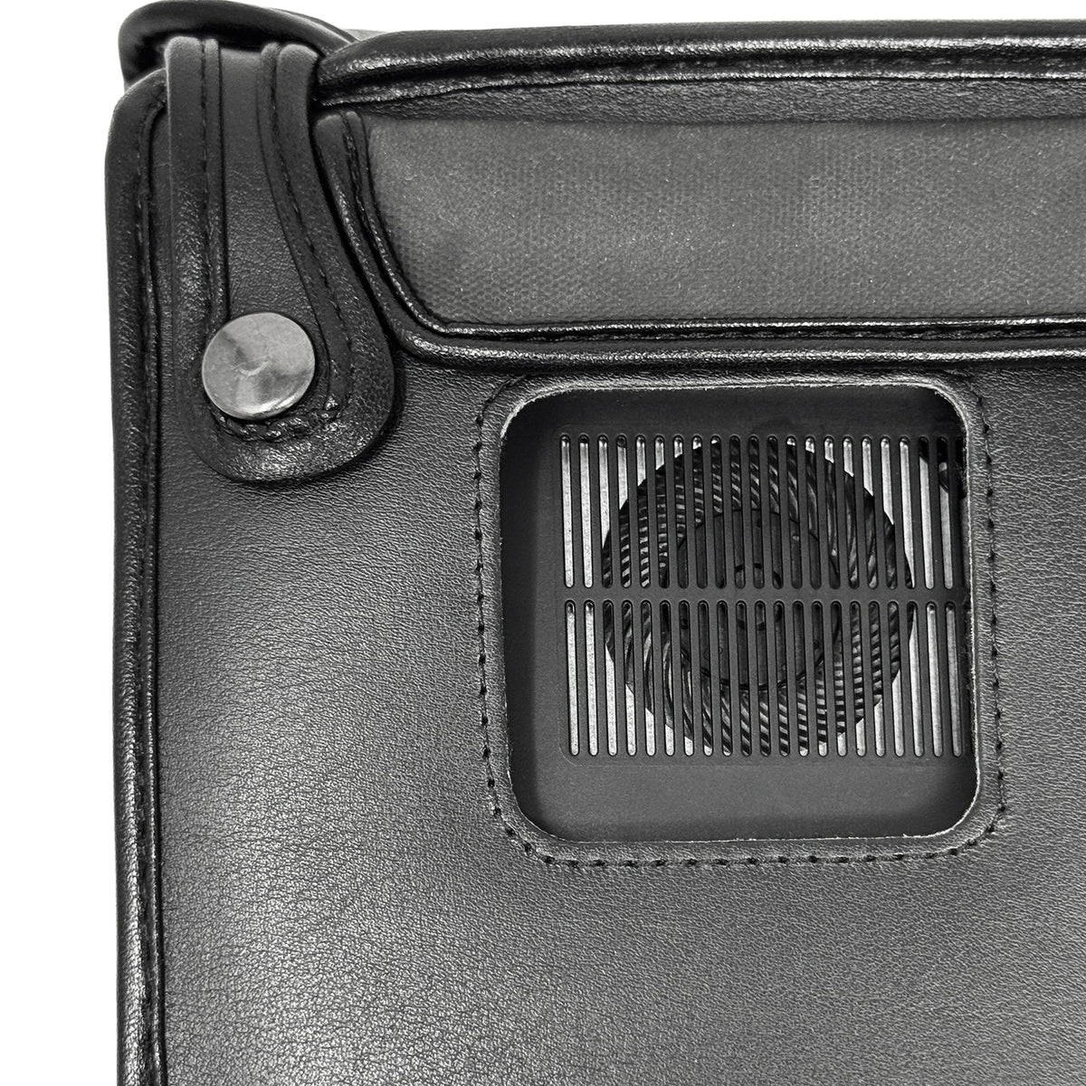 Close-up of the underside of the BrailleNote Evolve case, showing a metal snap and cutout around the built-in speaker grille.