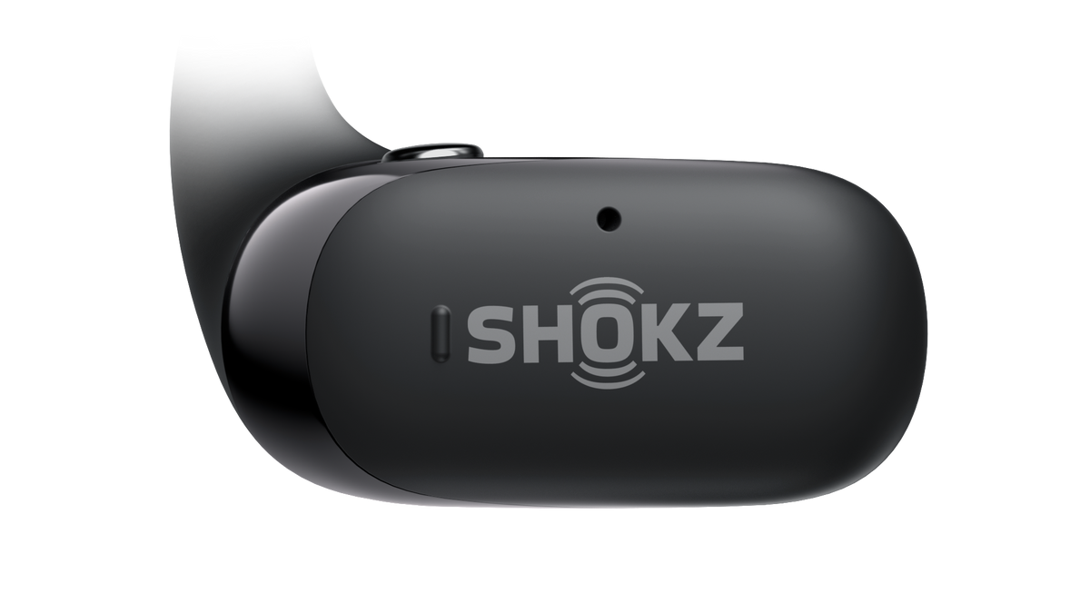 Black Shokz OpenFit 2 earbud on a solid black background