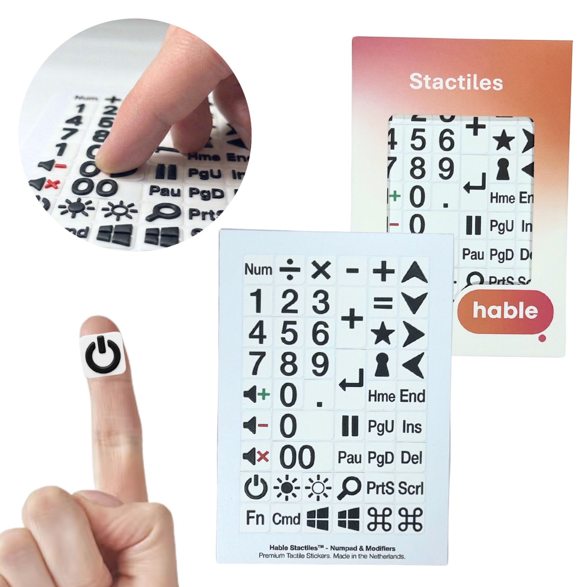 A composite image of the Hable Stactiles Numpad & Modifiers set. A circular inset shows fingers touching raised black-on-white keyboard stickers. A single power symbol sticker is shown on a fingertip for scale. The full sheet of 50 stickers includes a numeric keypad, mathematical operators, arrow keys, modifiers, and function keys. The retail box is visible on the right.