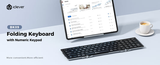 "An angled top-down view of the iClever BK09 Bluetooth Folding Keyboard. The keyboard is folded open, showing its full QWERTY layout with a dedicated numeric keypad on the right side. The keys are black with a sleek, modern design, and the keyboard features a compact, portable form. It is ultra-thin and perfect for mobile use, with easily accessible function keys at the top for multitasking and device switching."